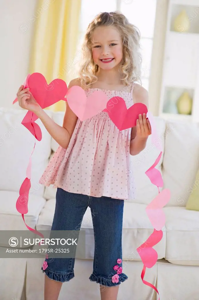 Young girl holding heart cut outs