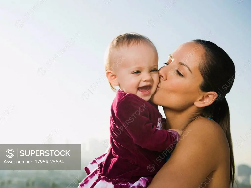 Woman kissing toddler