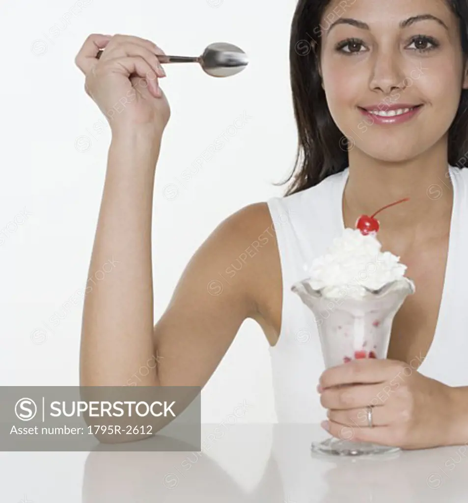 Smiling woman with ice cream sundae
