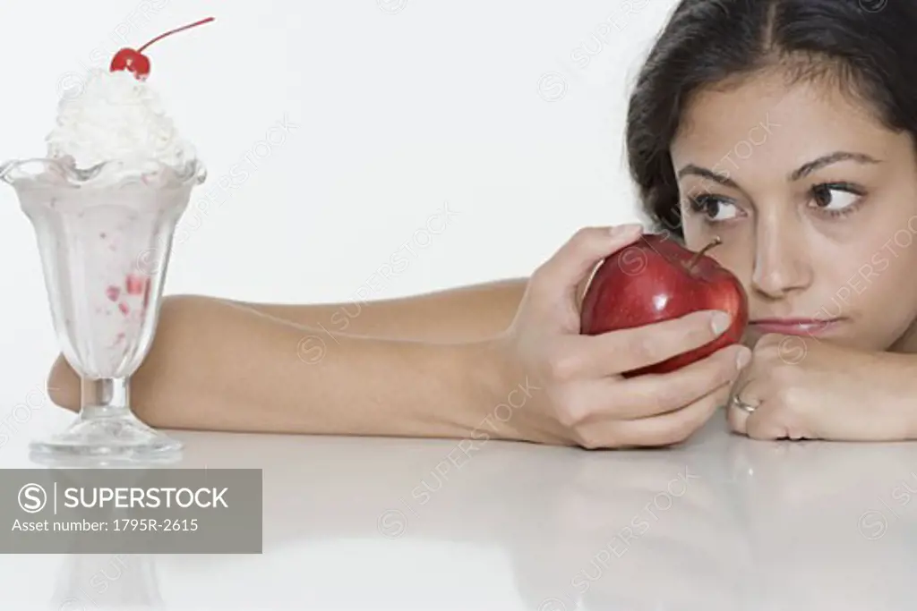 Woman with apple wanting ice cream sundae