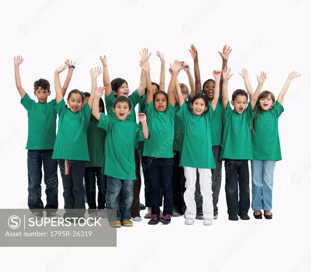 Group of children with their arms raised