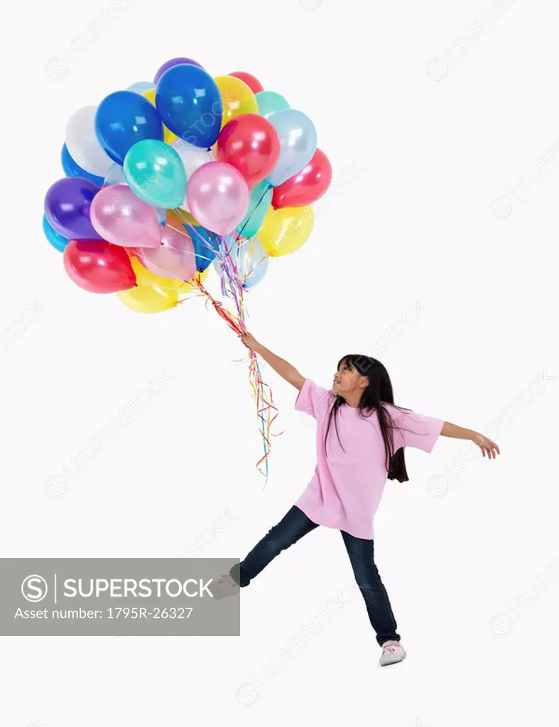 Girl holding balloons