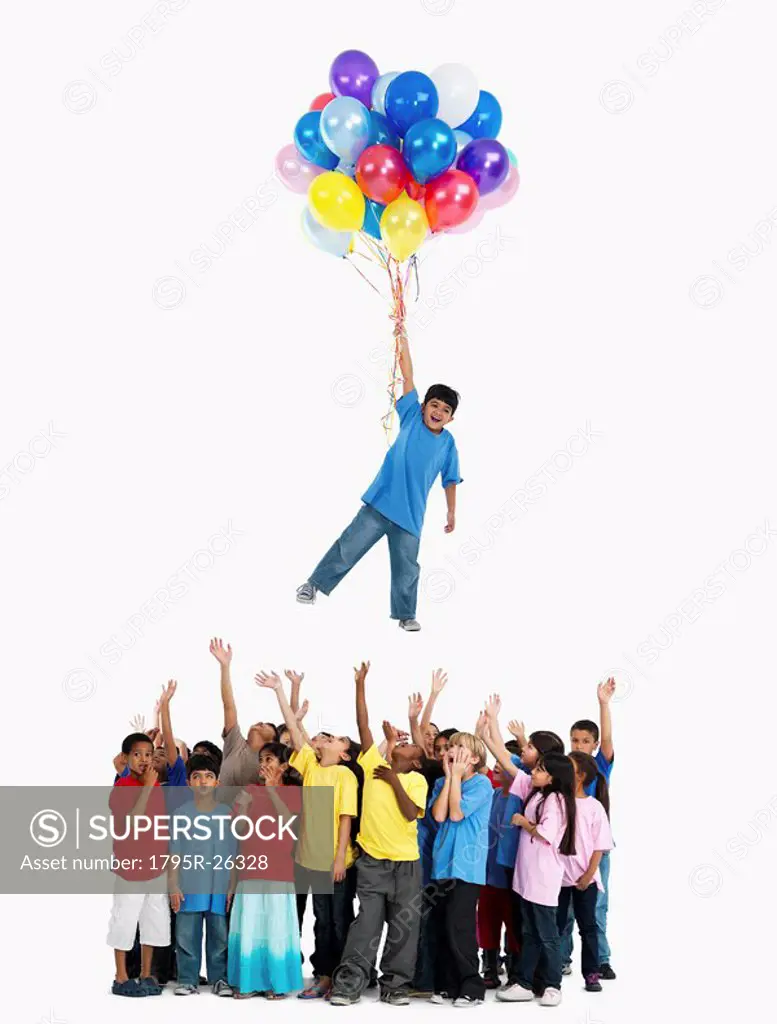 Boy floating away with balloons