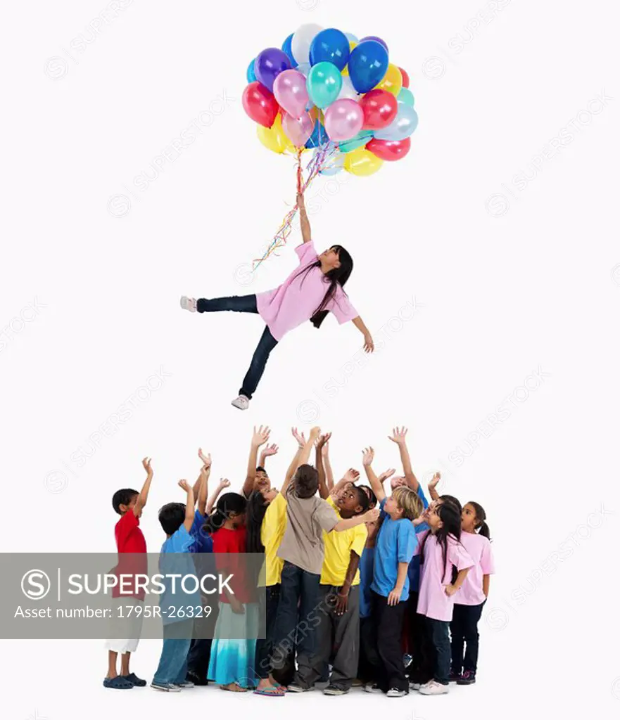 Girl floating away with balloons