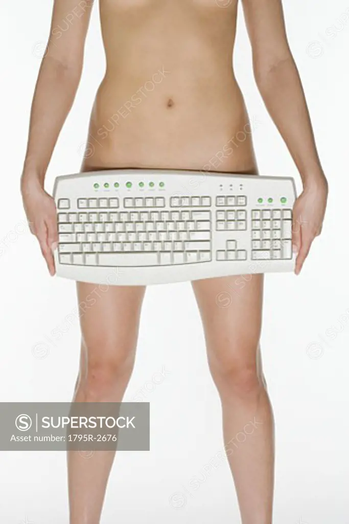 Nude female holding computer keyboard