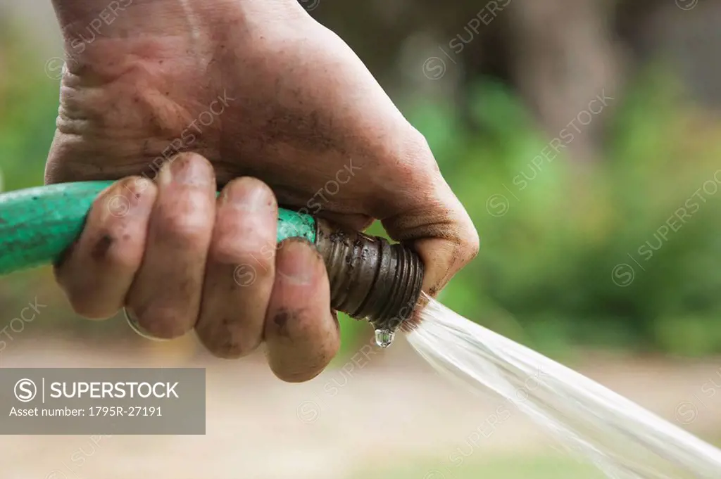 Hand holding hose