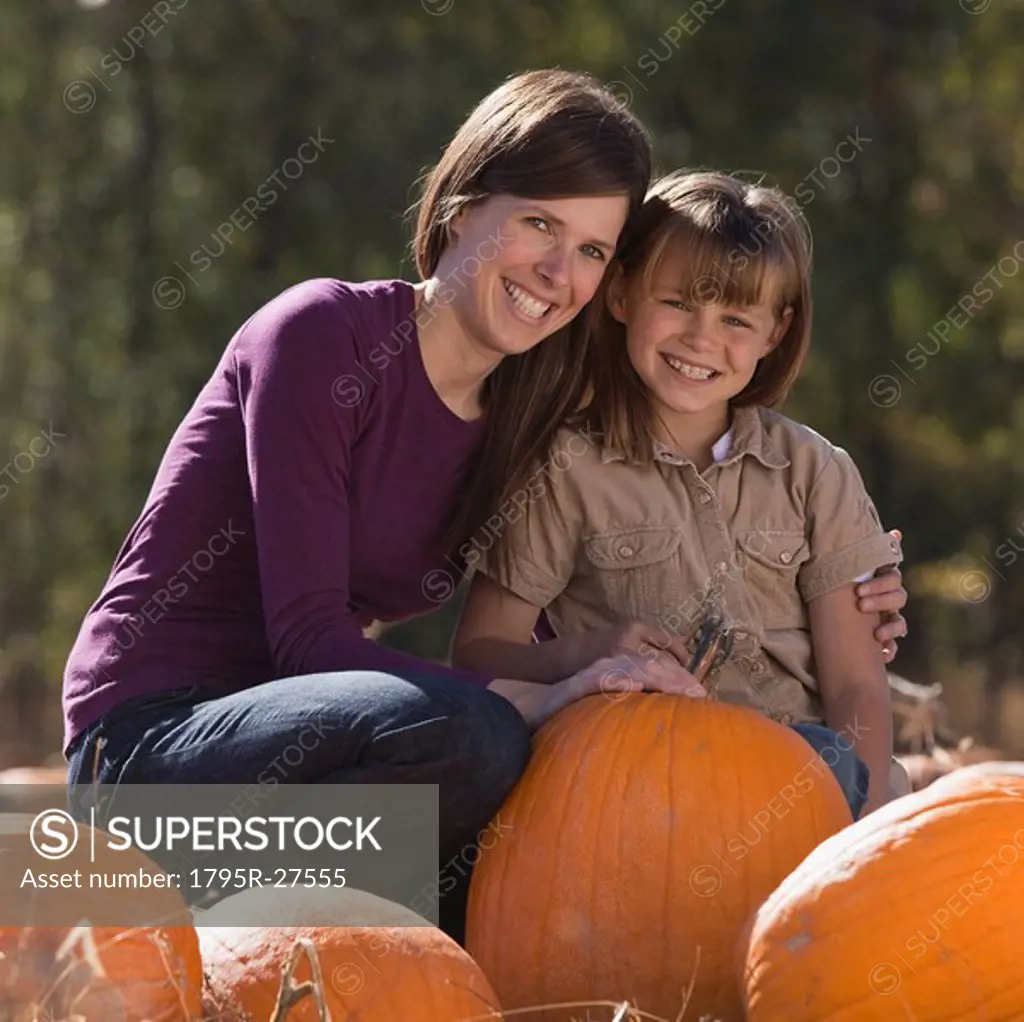 Mother and daughter in pumpkin patch