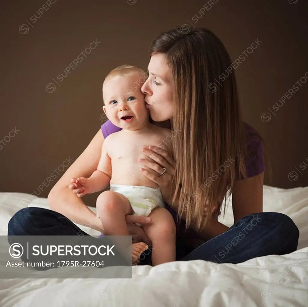 Woman kissing baby