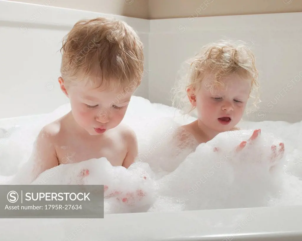 Children playing with bubbles in the bath tub