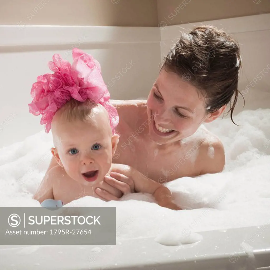 Mother and child having bubble bath