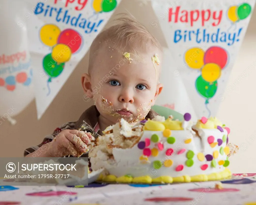 Baby eating birthday cake