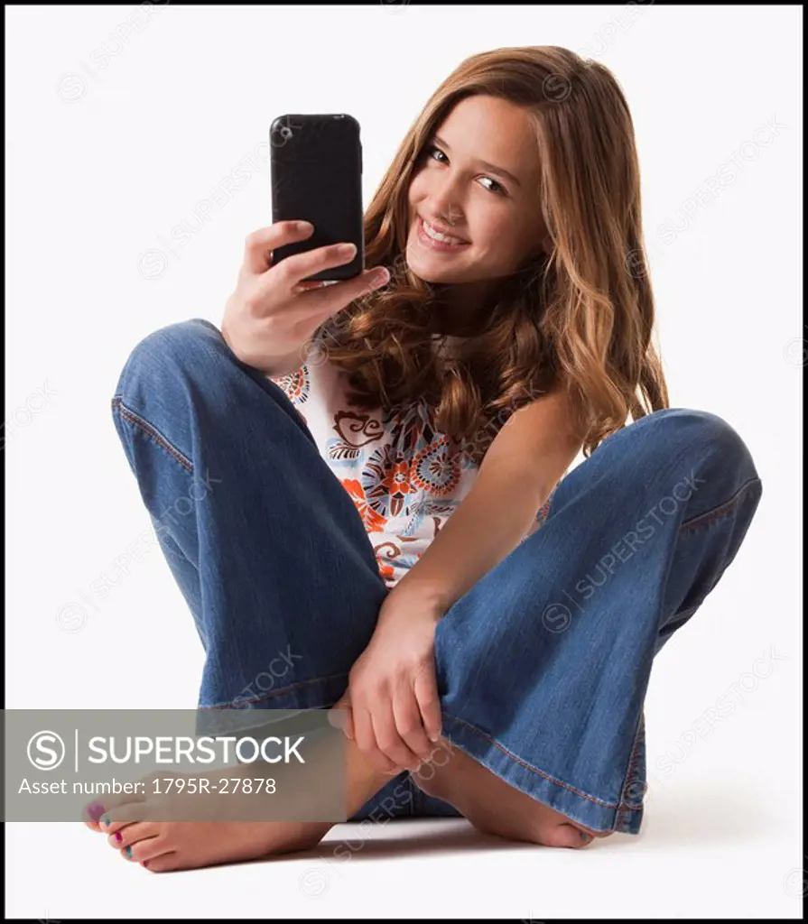 Young girl holding cellular phone