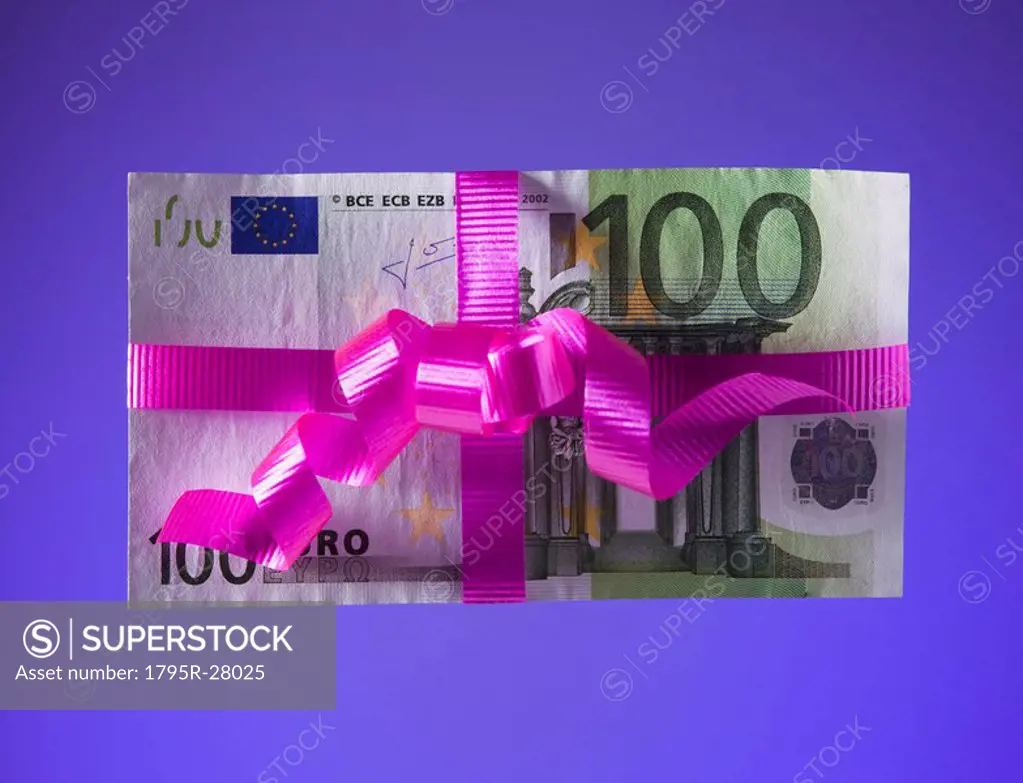 100 euro bill tied with a pink bow