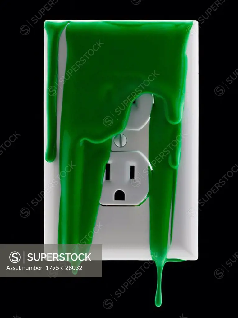 Electricity outlet covered in green paint