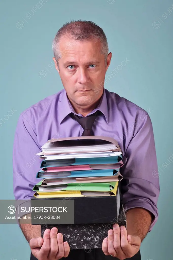 Man holding a stack of paper work