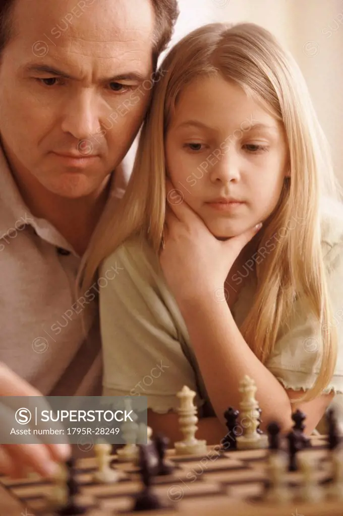 Father and daughter playing chess