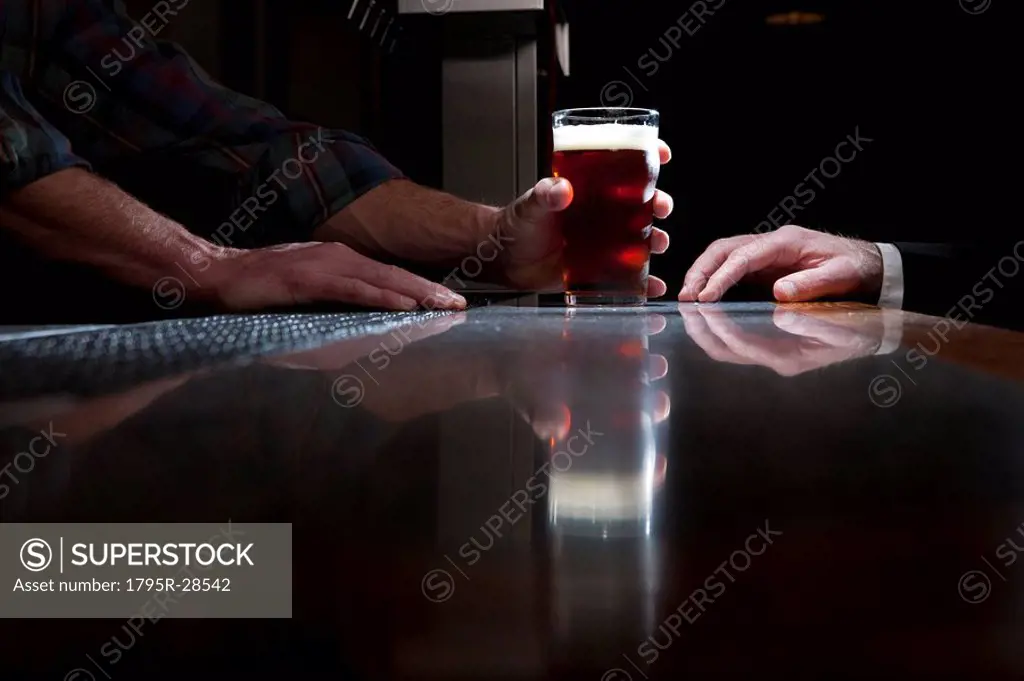 Bartender serving a beer