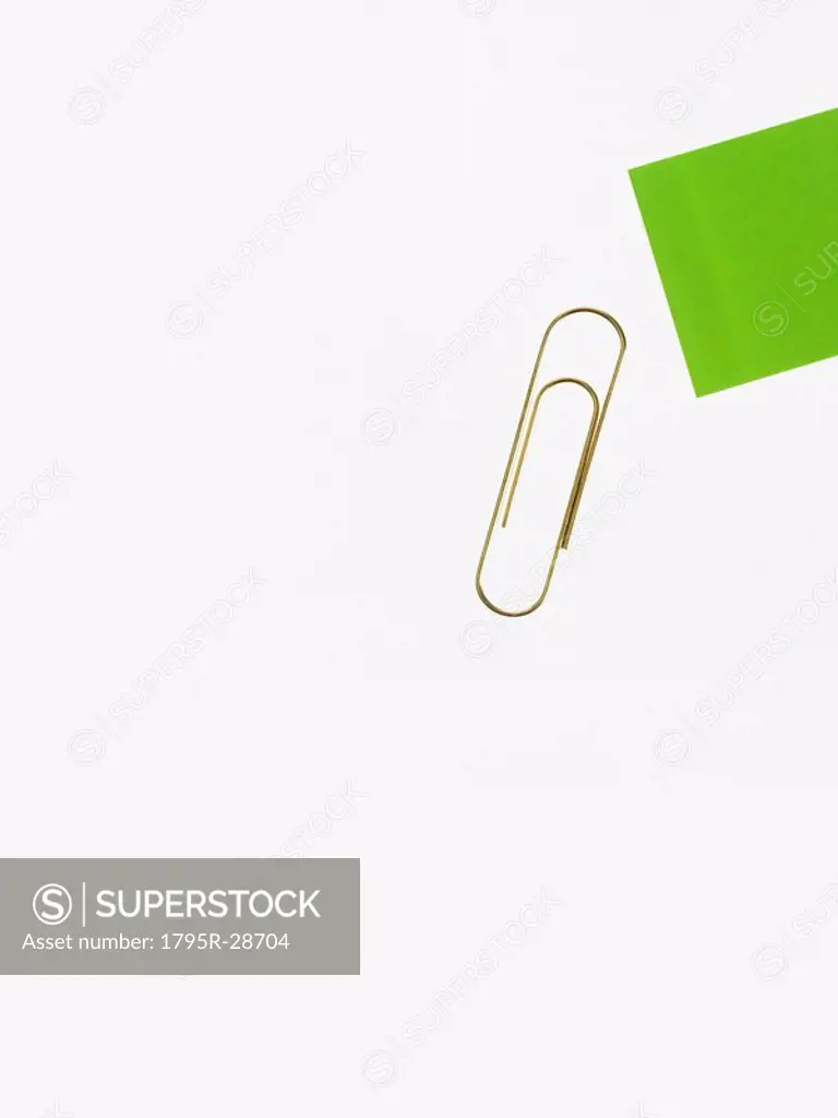 Paper clip and green paper
