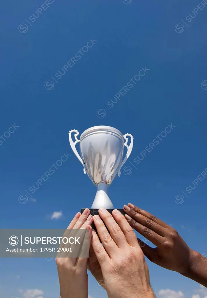 Hands holding trophy in the air