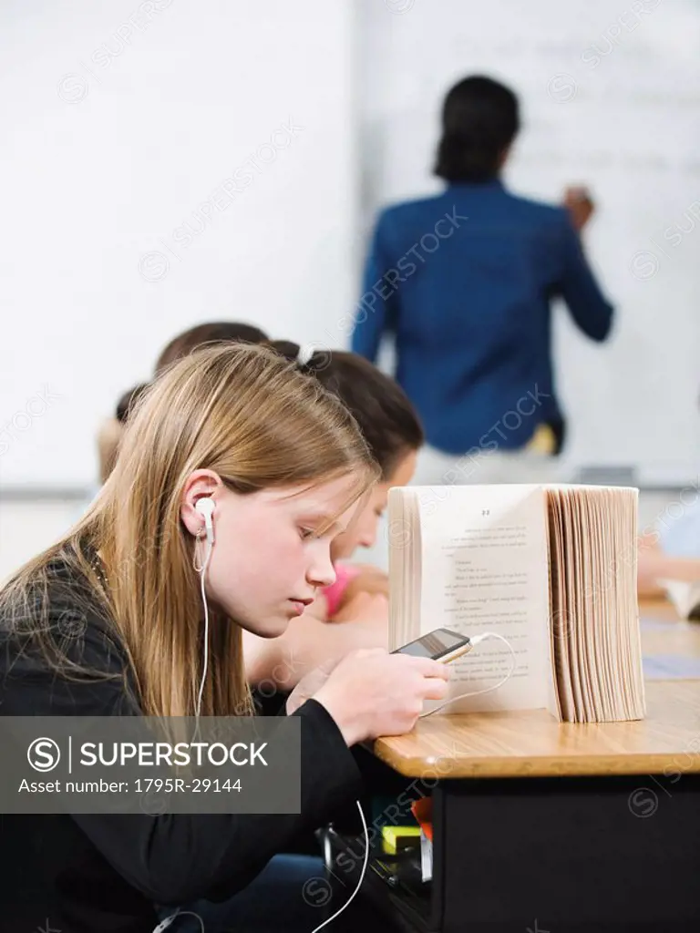 Student texting in classroom
