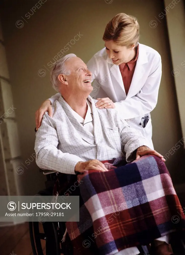 Doctor talking to senior man in wheelchair