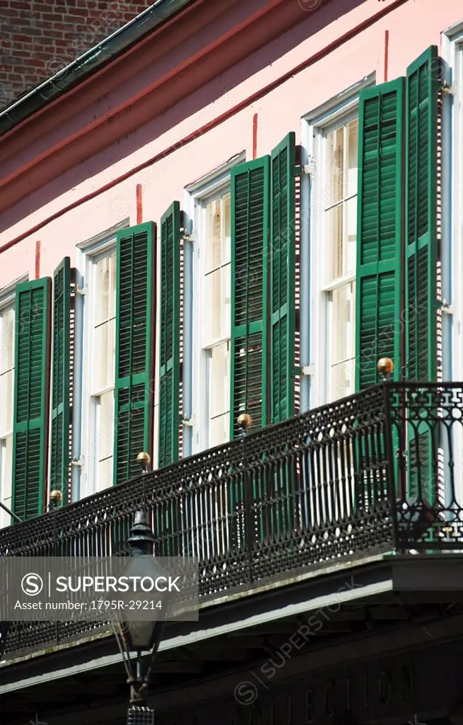 Balcony and windows with green shutters