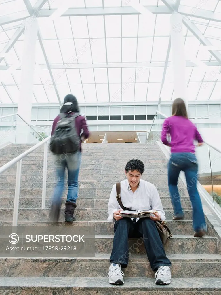 College students on steps in front of library