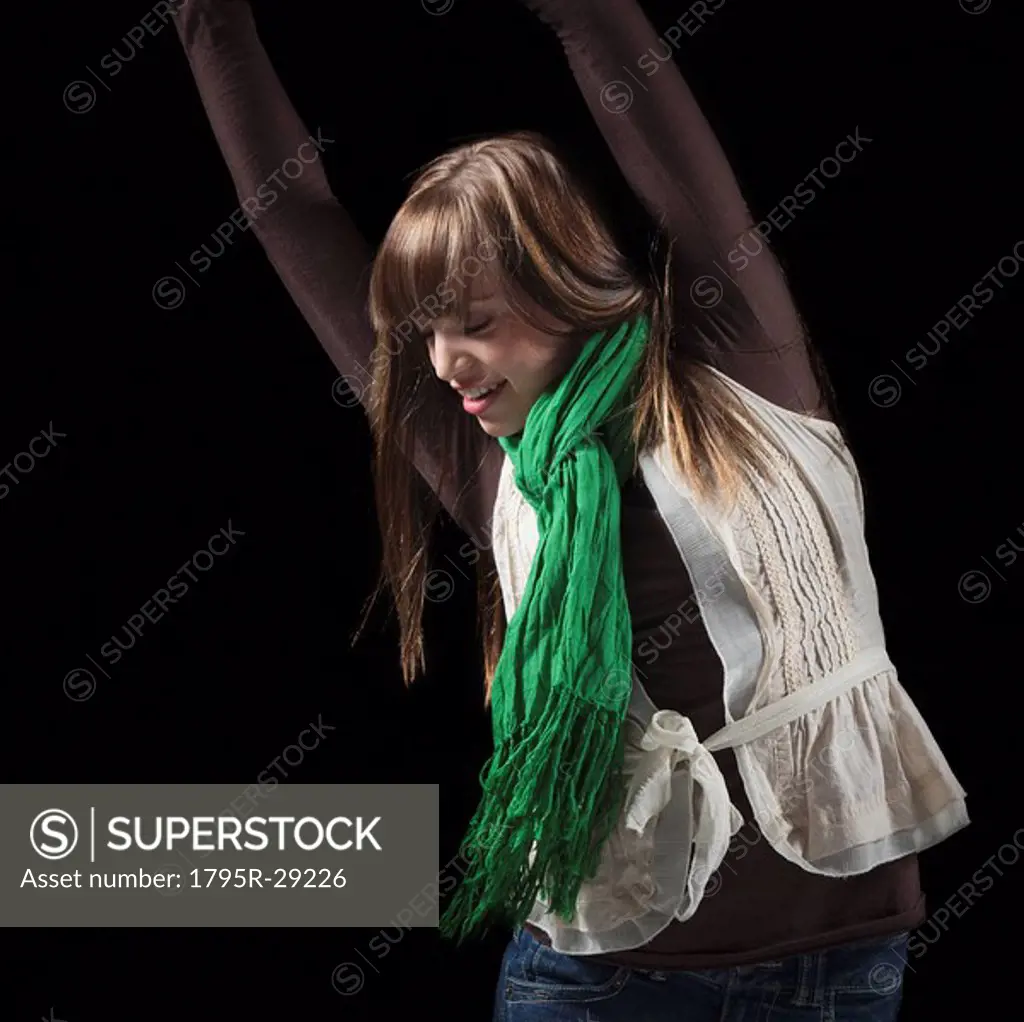 Female dancer with her arms raised above her head