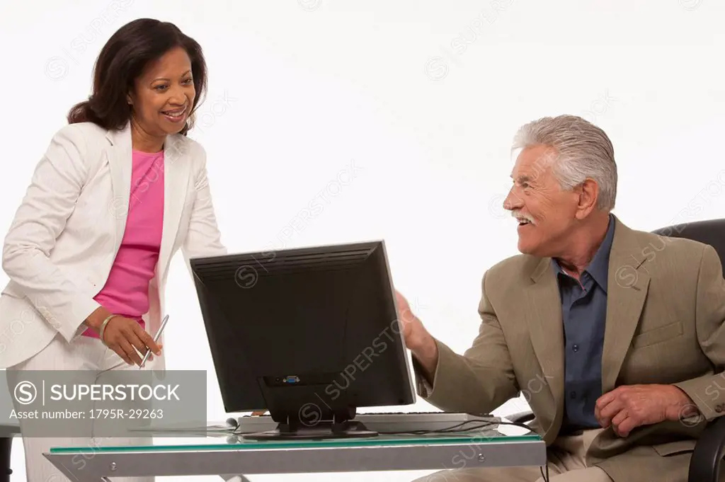Colleagues talking while looking at computer
