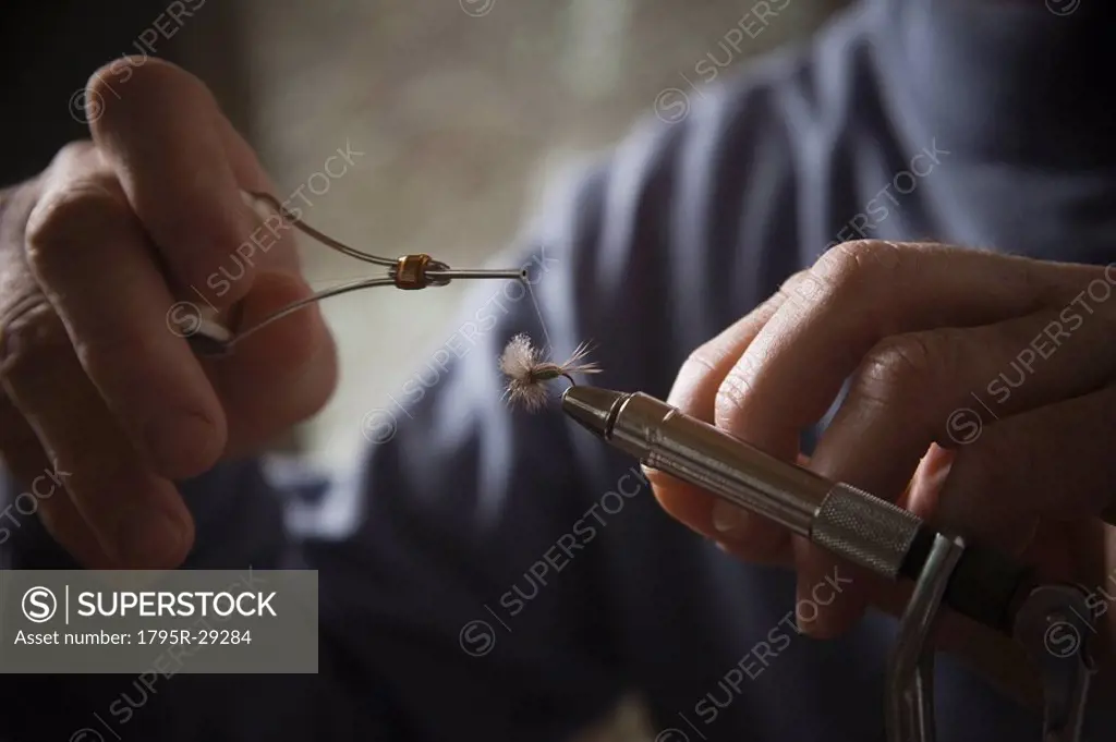 Hands working on fly fishing hook