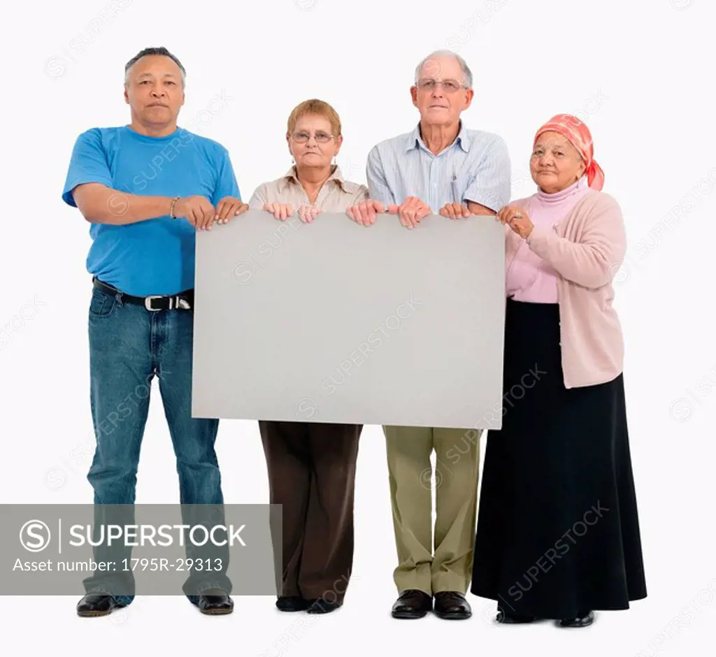 Four people holding a blank poster