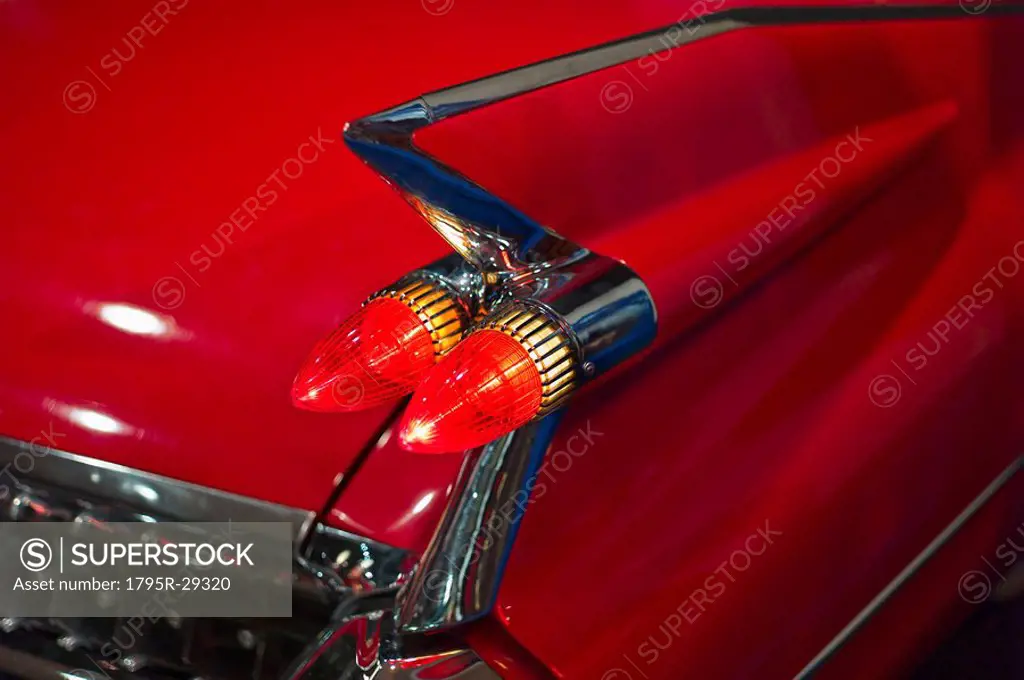 Tail fin on a 1959 red automobile
