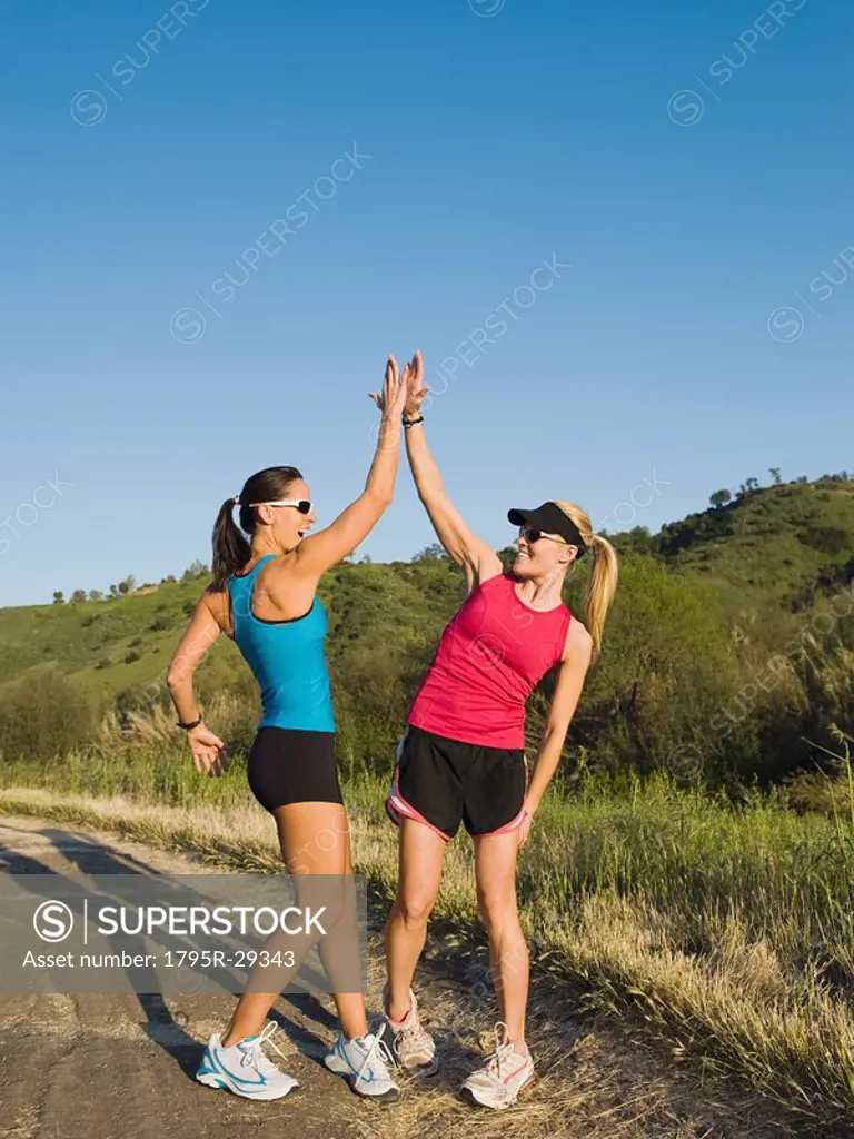 Two trail runners giving each other a high five