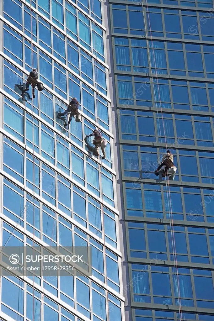 Window washers cleaning windows on skyscraper