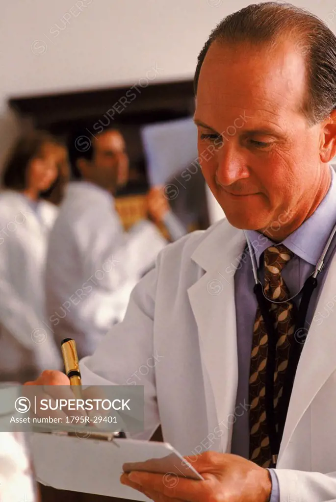 Doctor writing on his clipboard