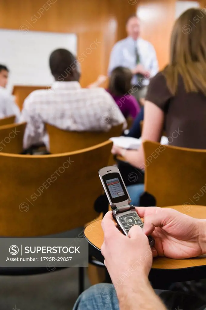 College student texting in lecture hall