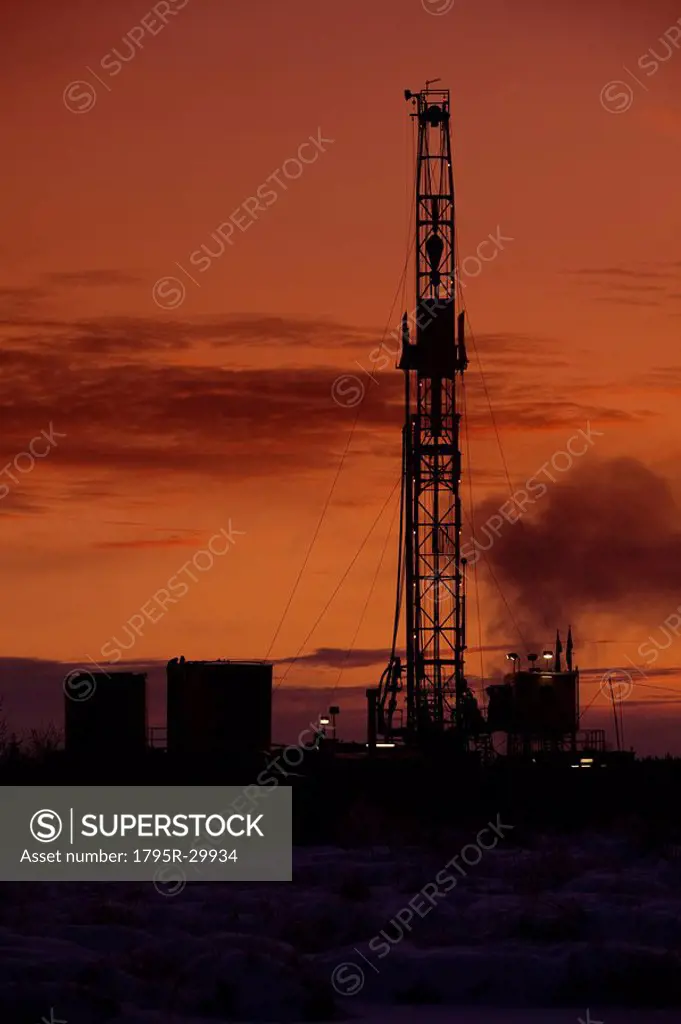 Oil drilling rig at dusk