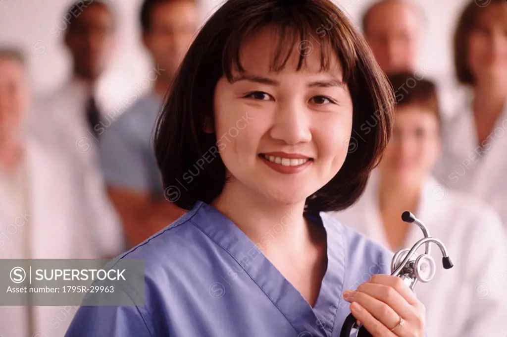 Portrait of a doctor with medical team in the background