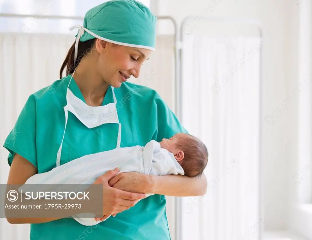 Nurse holding swaddled baby