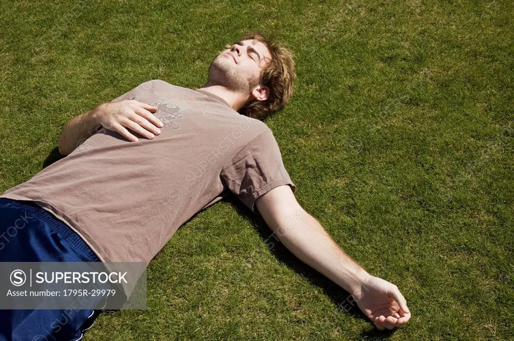 Defeated athlete lying on the grass