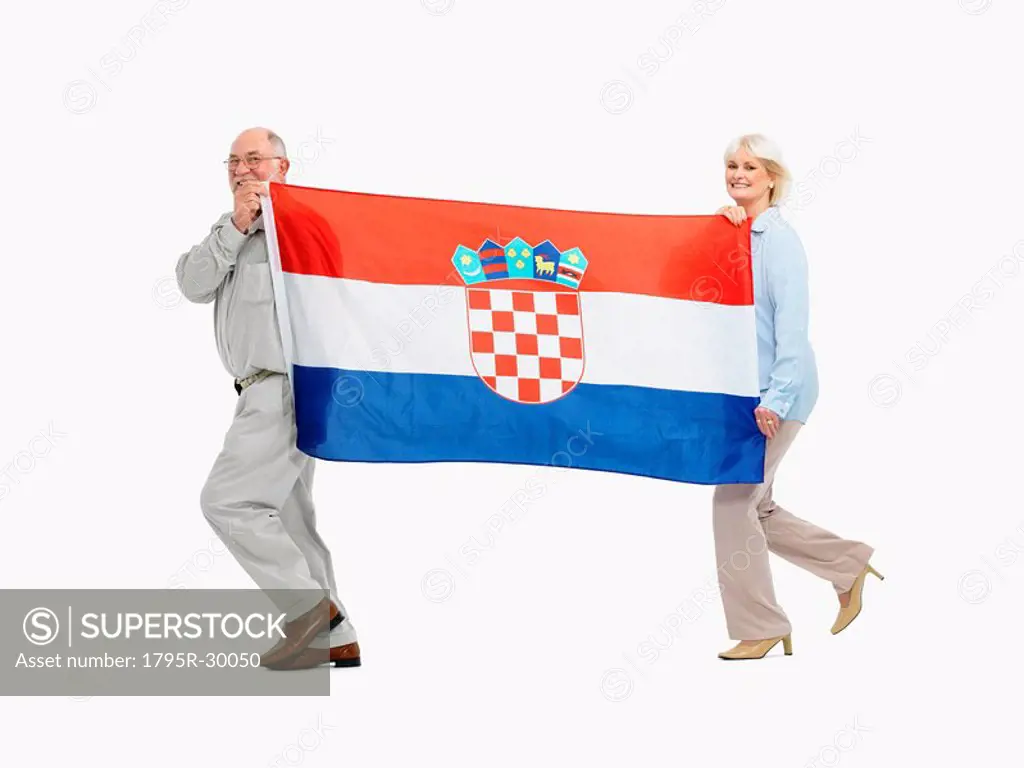Two people carrying the Croatian flag