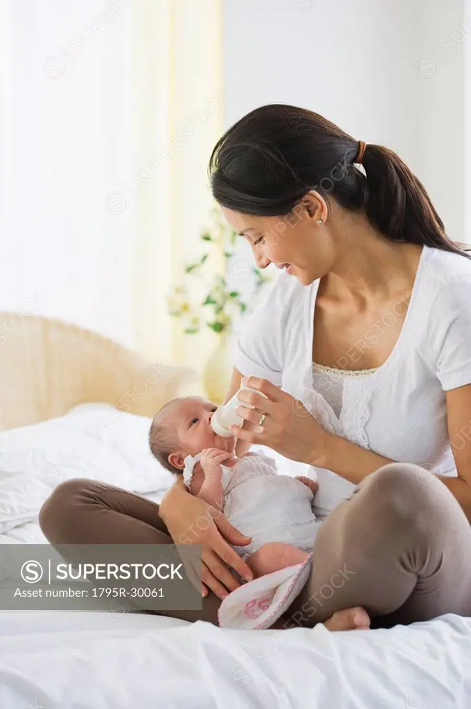 Mother feeding her baby a bottle