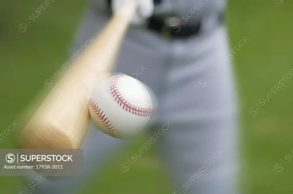 Closeup of baseball player hitting ball