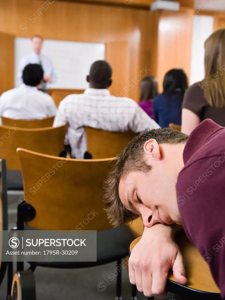 College student sleeping in lecture hall