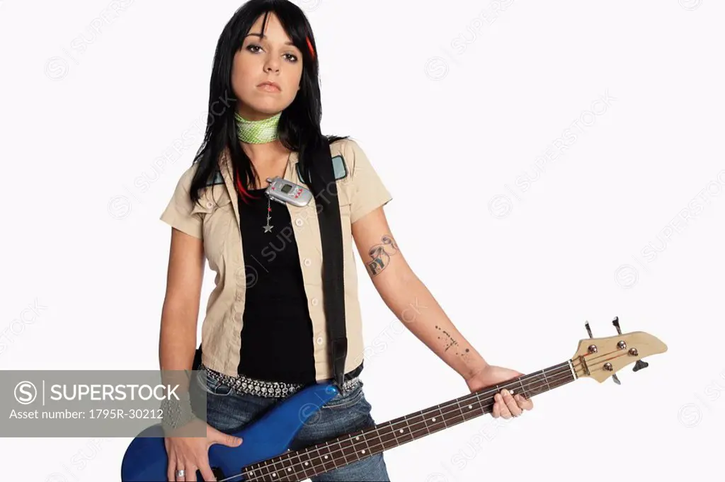 Teenage girl playing electric guitar