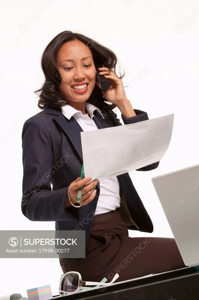 Businesswoman sitting on desk
