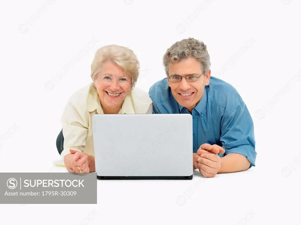 Retired couple looking at laptop together