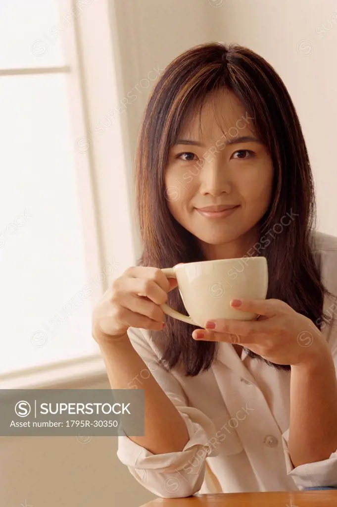Attractive woman holding a cup of coffee