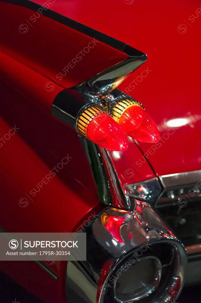 Tail fin on a 1959 red automobile