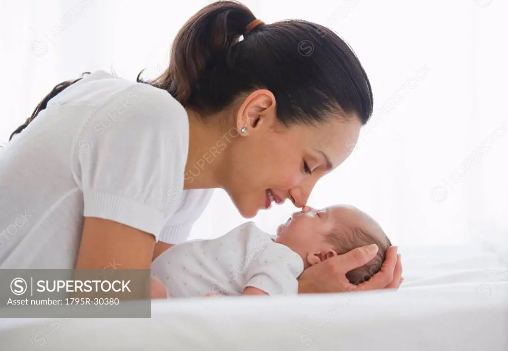 Mother gazing at her sleeping baby